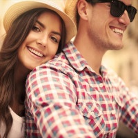 Close up of loving couple riding on bike in the city