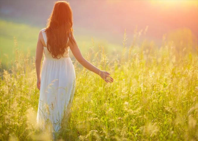 Bride Enjoying Nature. Free Happy Woman. Lit evening sun. Freedom concept.