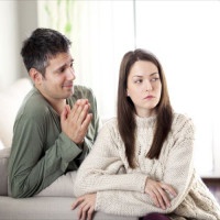 Image of young man begging his girlfriend to forgive him