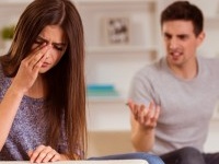 Young couple quarrels among themselves at home, his wife was crying because her husband,  at home