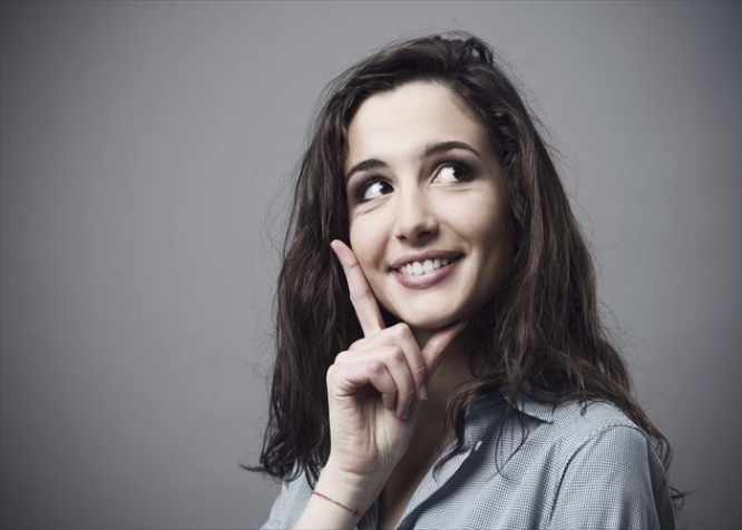 Beautiful young woman thinking with hand on chin