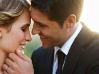 A cute couple gently embracing as the sun sets on their wedding day