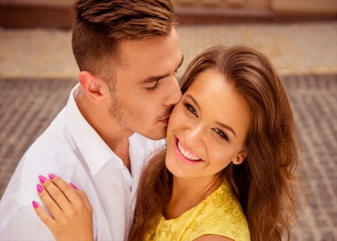 handsome young man kissing his beloved's cheek