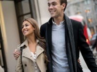 Young couple walking on the street in the city hugging and looking very happy