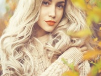 Outdoor fashion photo of young beautiful lady surrounded autumn leaves