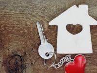 small house and a key with a keychain in shape of heart