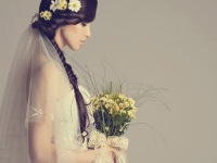 Studio shot of young beautiful bride on light background. Professional make up and hair style.