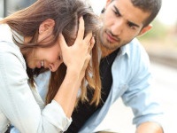 Muslim man comforting a sad girl mourning