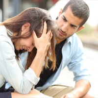 Muslim man comforting a sad girl mourning