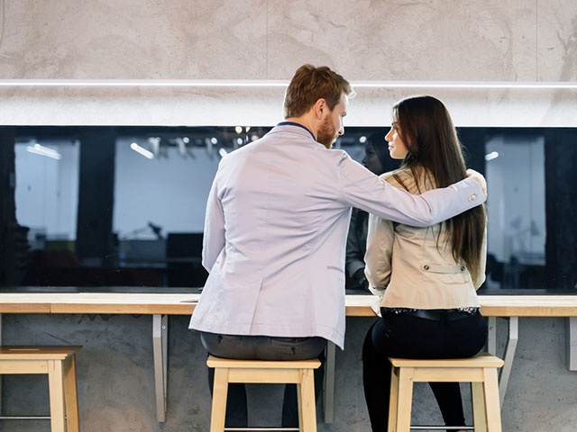 Handsome man hugging a woman in a bar