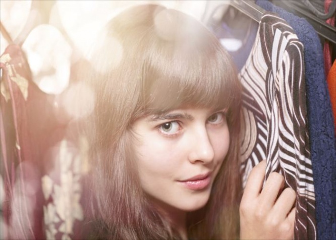portrait of a beautiful teenage girlan her warderobe, with bokeh