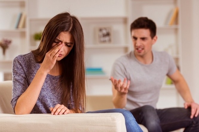 Young couple quarrels among themselves at home, his wife was crying because her husband,  at home