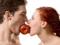 Couple biting an apple, isolated on white