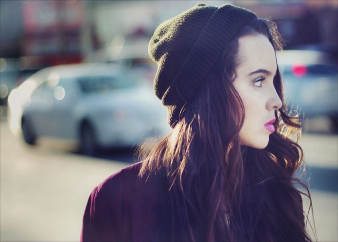 Stock image portrait of urban teen walking outdoors with a blank stare