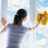 young woman washing windows