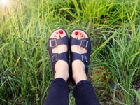 Woman  feet on green grass background