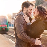 Happy couple embracing on railway station platform