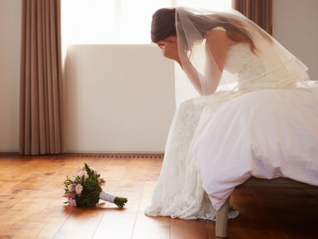 Bride In Bedroom Having Second Thoughts Before Wedding