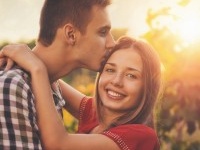 Attractive couple enjoying romantic date in the Countryside, sunset in the background