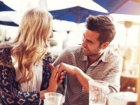 romantic couple drinking beer with artistic lens flare