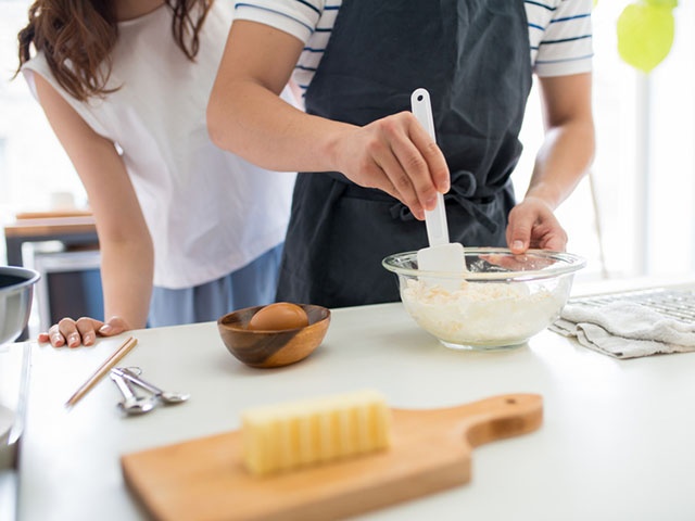 Young couple in the kitchen cooking together. Kyoto, Japan. May 2016