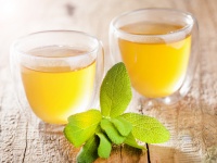 herbal sage tea with green leaf in glass cup