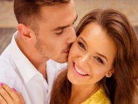 handsome young man kissing his beloved's cheek