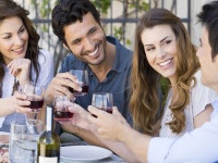 Group Of Happy Young Friends Toasting Wine Glass Outdoor While Having Lunch