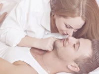Sexual scene of gentle and affectionate young couple in the bedroom