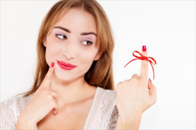 woman red bow on finger, isolated on white background