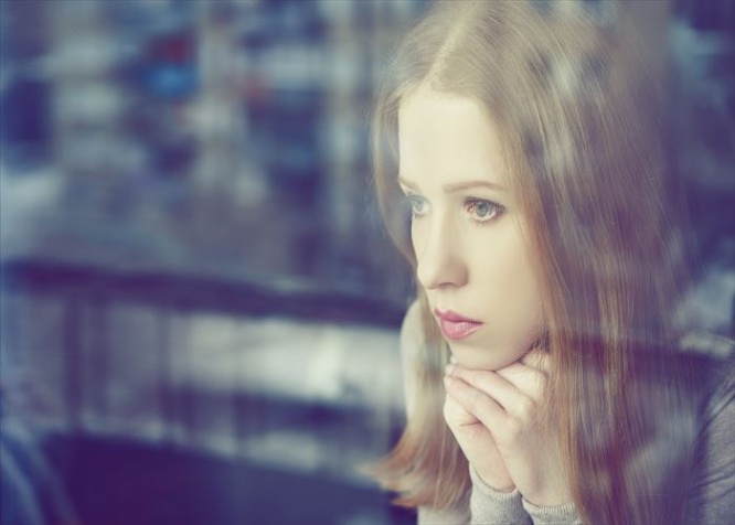 alone thoughtful sadness girl is sad at the window