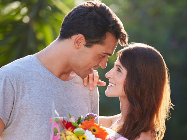 Romantic Man Giving Woman Bunch Of Flowers