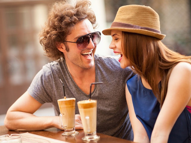 Happy couple enjoying sitting in cafe