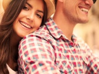 Close up of loving couple riding on bike in the city