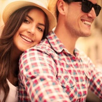 Close up of loving couple riding on bike in the city