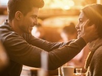 Affectionate man sitting in a cafe with his girlfriend and expressing his love on a romantic way.