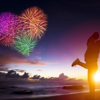 sunset silhouette of young couple in love hugging on beach