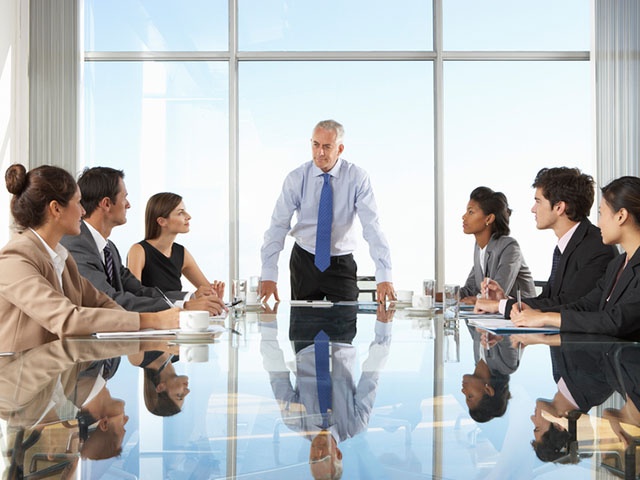 Group Of Business People Having Board Meeting