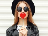 Fashion sweet woman having fun with lollipop over white background