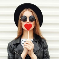 Fashion sweet woman having fun with lollipop over white background