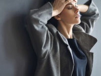 Portrait of tired beautiful woman on dark background