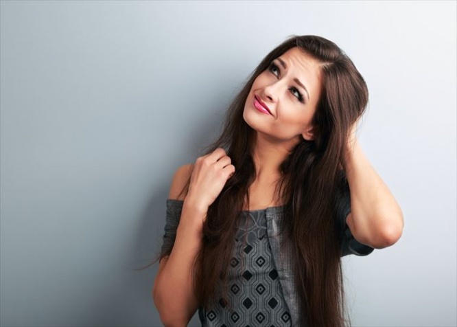 Confusion fashion makeup brunette woman thinking and looking up on blue copy space background