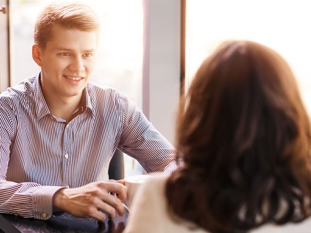 Young couple in cafe enjoying each other