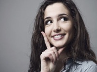 Beautiful young woman thinking with hand on chin