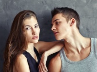 fashion beautiful young couple on grey wall background