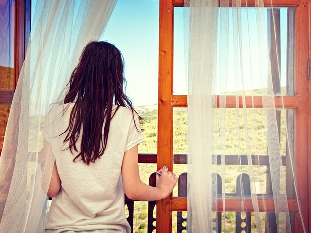 Girl looking out window