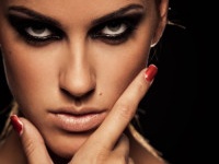 Closeup portrait of a serious lady with smoky eye makeup