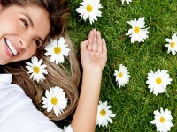 Beautiful woman lying on a flower granden enjoying her time outdoors