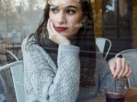 Portrait of beautiful young woman drinking tea in a coffee shop.