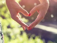 Young couple in love holding hands in the sunset in summer evening. Bright toning picture